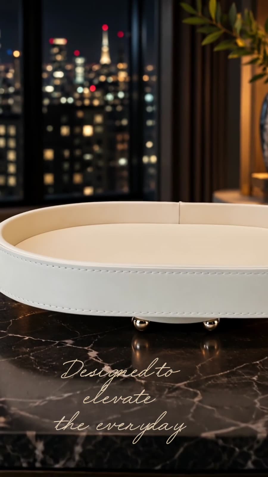 Ivory tray on dark marble with a night skyline behind