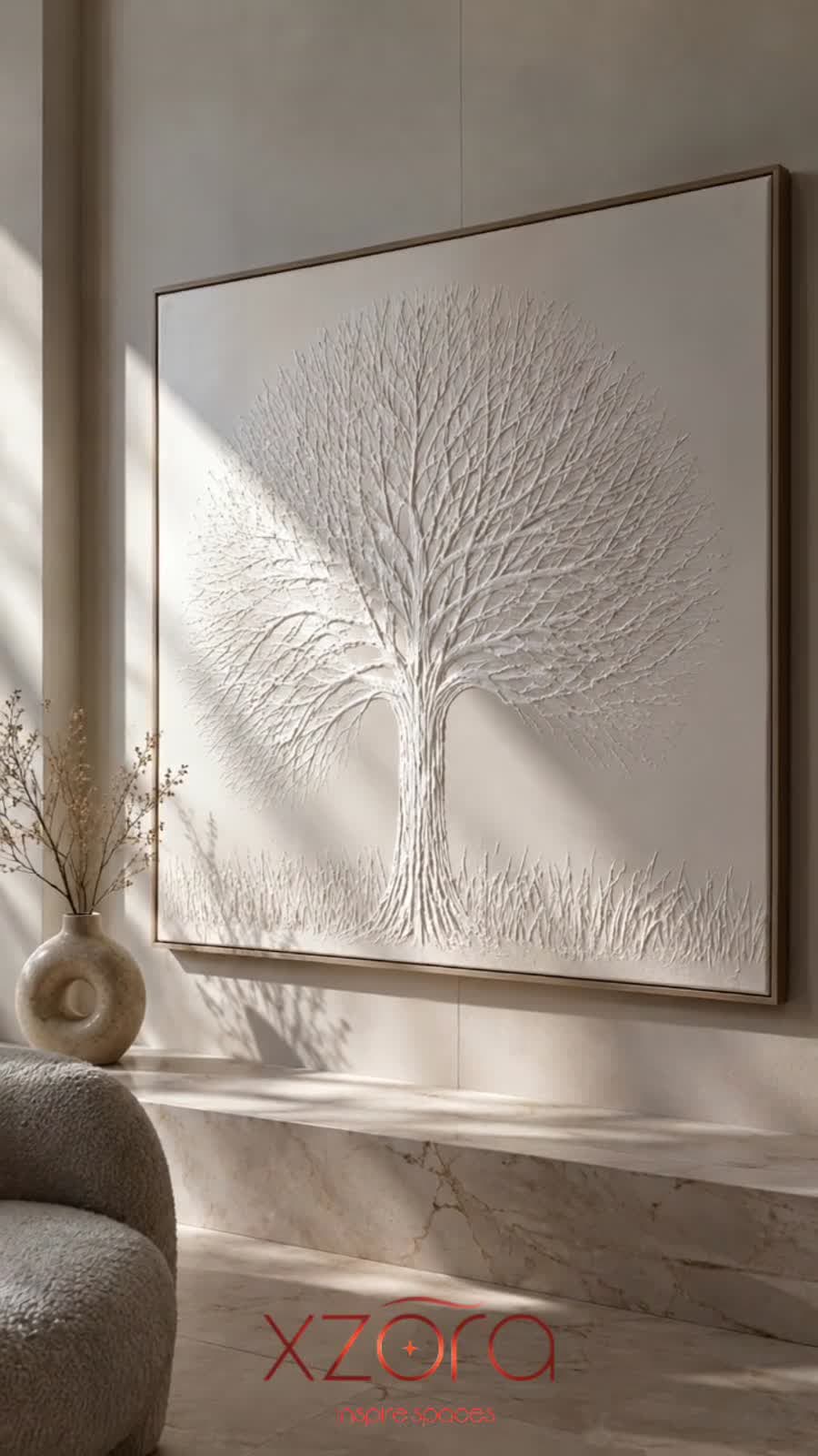 White sculptural tree relief on a plaster wall in daylight